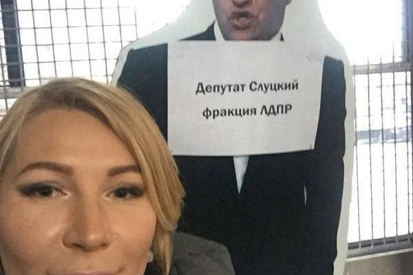 Popova with a poster